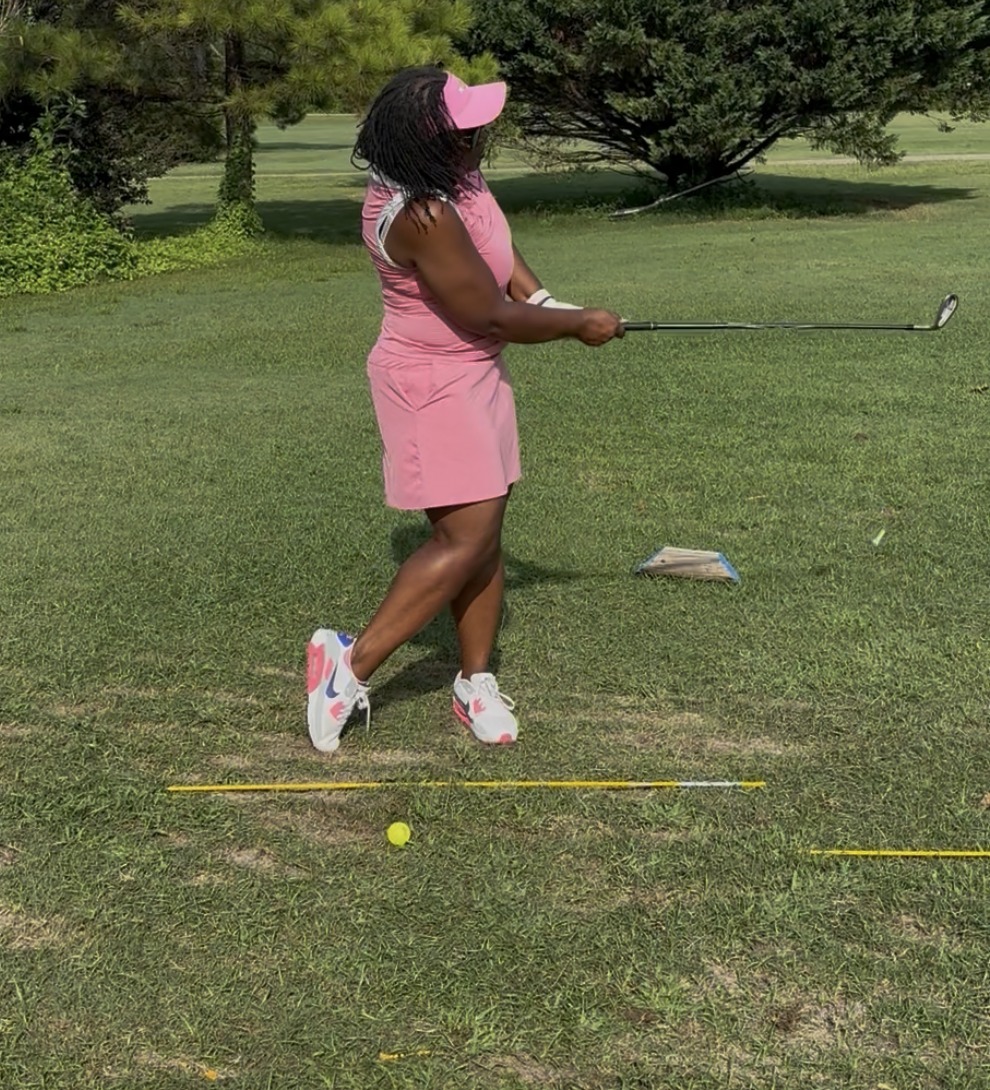 Chamarlyn Fairly, a Ladies of the Links member, mid-swing at the range.
